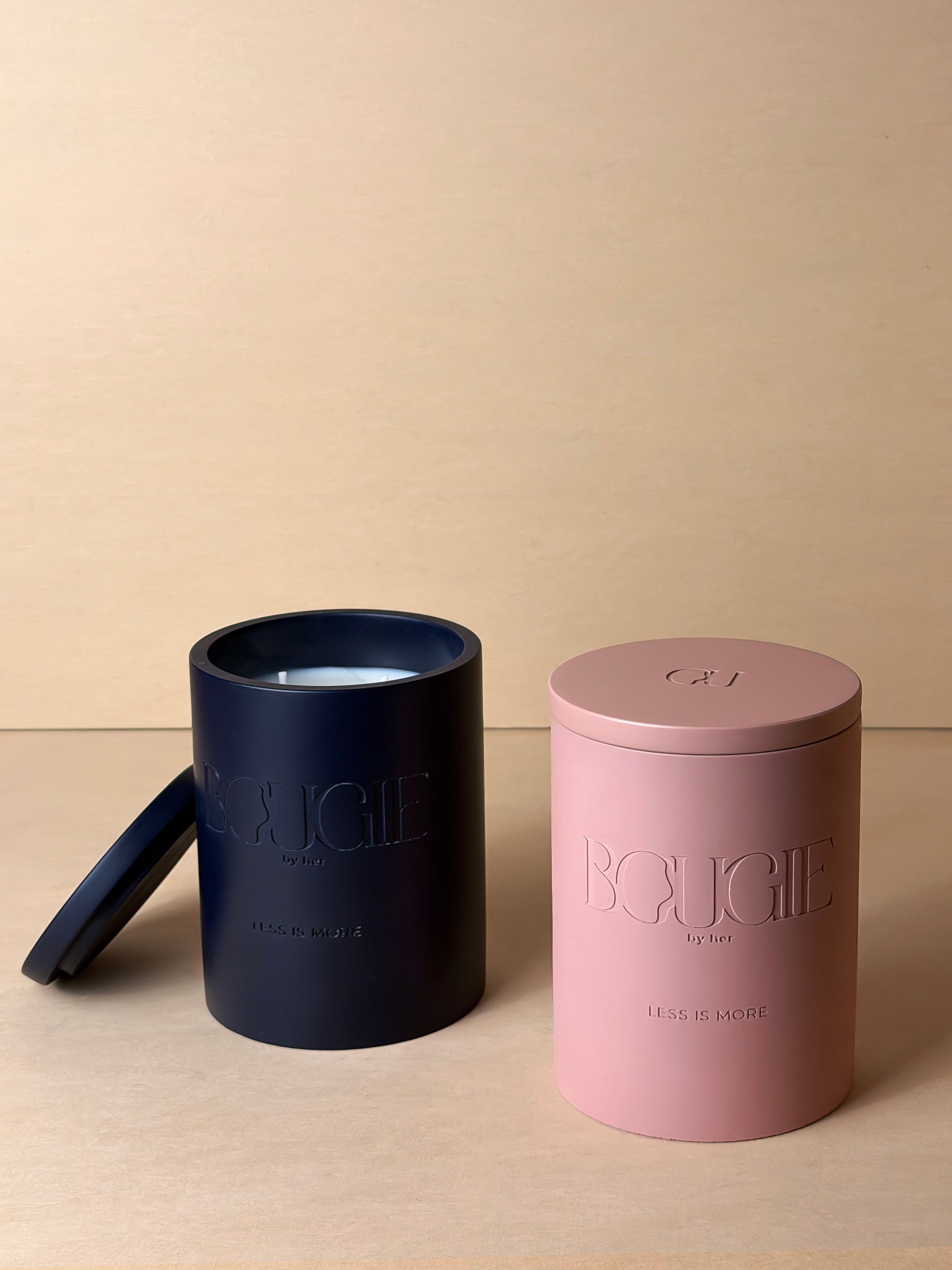 Two Bougie By Her candles in navy and pink containers